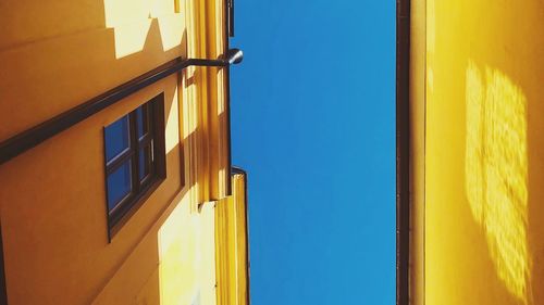 Low angle view of building against clear blue sky