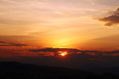 Scenic view of silhouette landscape against romantic sky at sunset