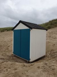 Beach hut against sky