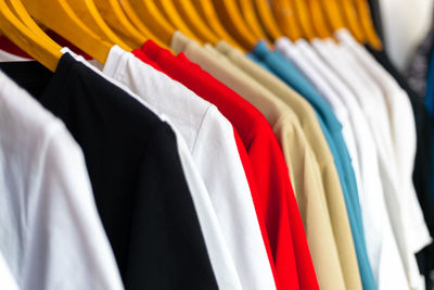 Multi colored clothes hanging on rack in store