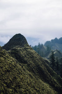 Scenic view of mountains against cloudy sky