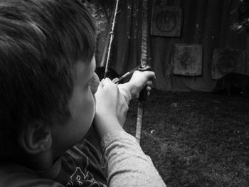 Close-up of boy aiming at target