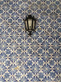 Lamp on tiled wall