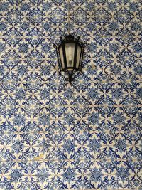 Lamp on tiled wall