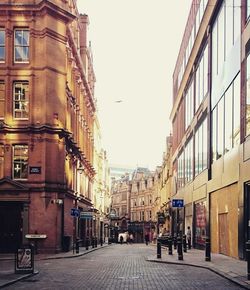 Surface level of street in city against clear sky