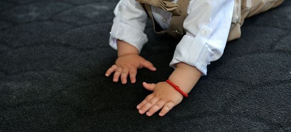 Low section of  boy sitting on floor