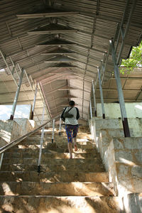 High angle view of man walking on staircase in building