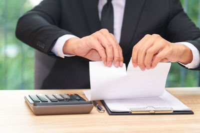 Midsection of man wearing mask on table