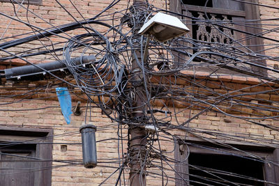 Tilt image of telephone pole against built structure