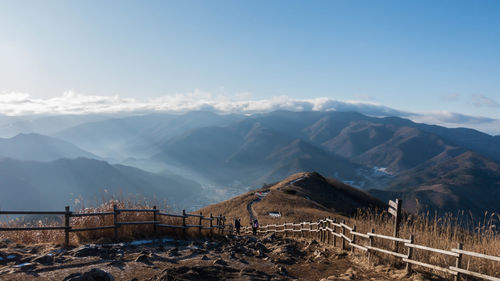 Scenic view of mountains against cloudy sky