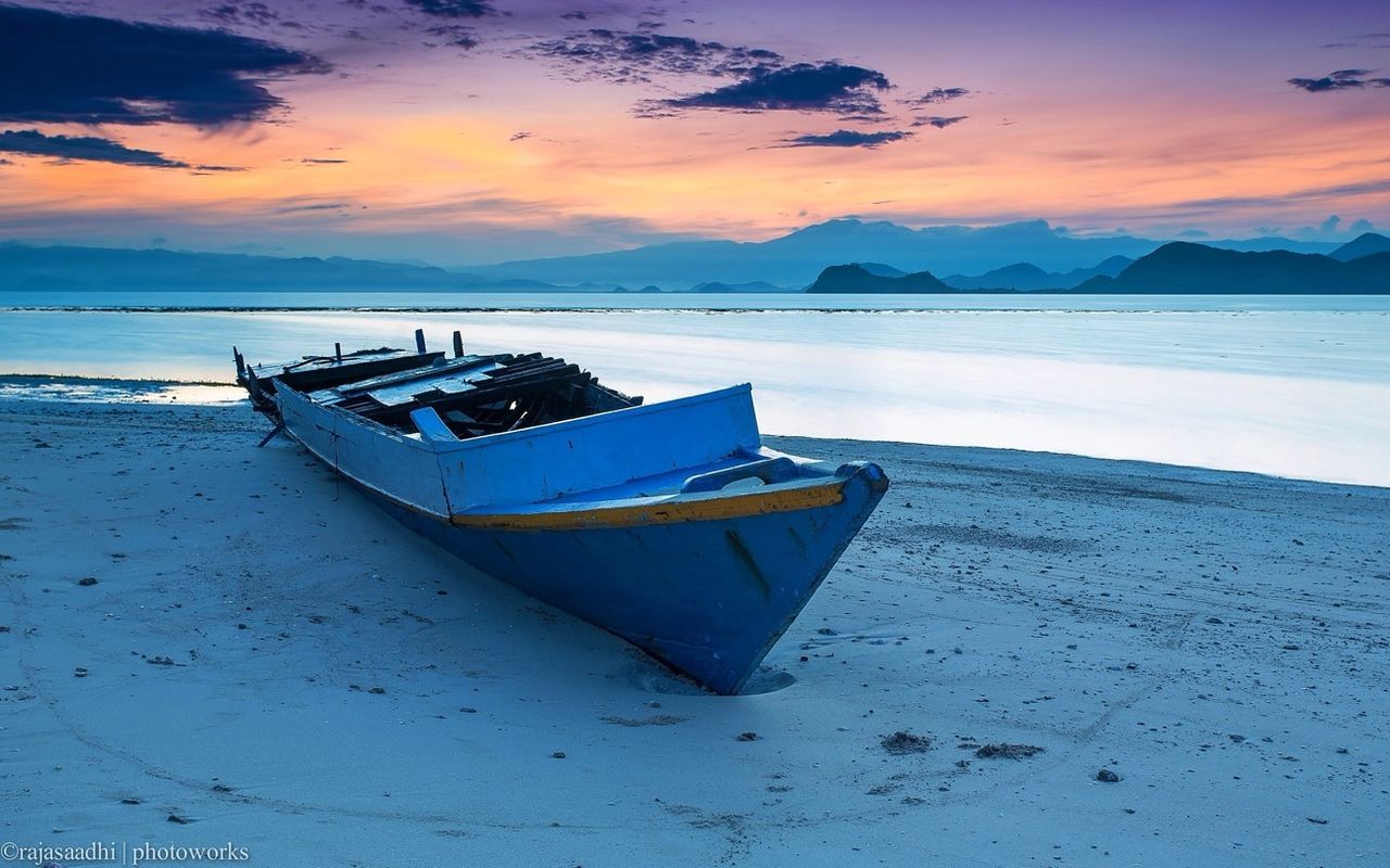 water, sky, sea, mountain, tranquility, tranquil scene, nautical vessel, beach, scenics, boat, beauty in nature, sunset, moored, transportation, nature, shore, sand, cloud - sky, mode of transport, idyllic