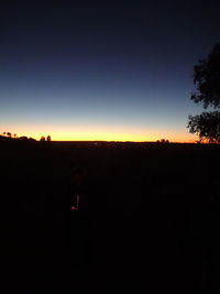 Silhouette landscape against clear sky