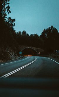 Car drives along the tunnel in the roadway at night