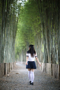 Full length of woman walking on footpath