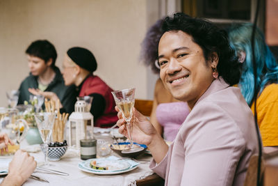 Portrait of young woman having food at home