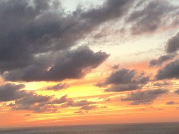 Scenic view of dramatic sky over sea during sunset