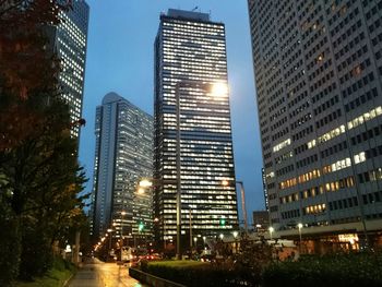 Low angle view of skyscrapers lit up at night