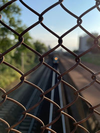 Close-up of chainlink fence against sky