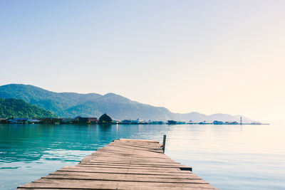 Pier over sea against clear sky