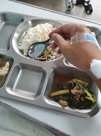 High angle view of man with heparin or iv  lock eating food for patient in hospital. 