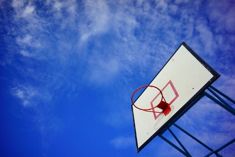 low angle view, sky, blue, cloud - sky, cloud, hanging, lighting equipment, built structure, outdoors, no people, day, cloudy, architecture, high section, building exterior, street light, nature, balloon, sunlight, lantern