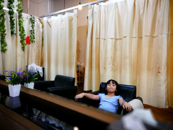 Young man sitting on sofa