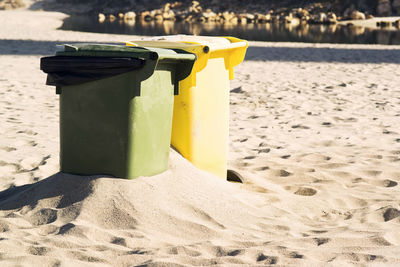 Close-up of garbage bin at beach