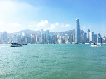 Sea and cityscape against sky