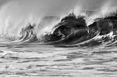 Close-up of waves in sea against sky