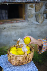 Midsection of man holding fruits in basket
