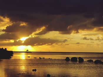 Scenic view of sea against orange sky