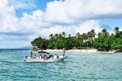 Panoramic view of people on sea against sky