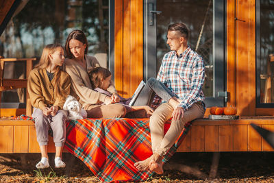 Rear view of people sitting at home