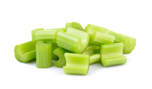 Close-up of chopped vegetable over white background