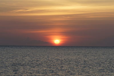 Scenic view of sea against orange sky