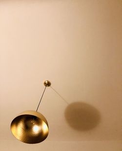 Close-up of lighting equipment on table against wall