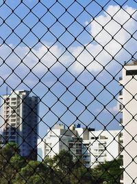 Modern building seen through chainlink fence