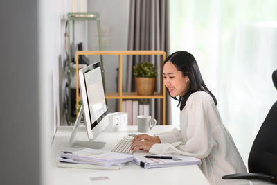Businesswoman working at desk in office