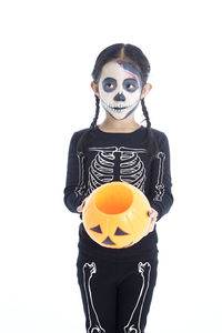 Young woman wearing mask against white background