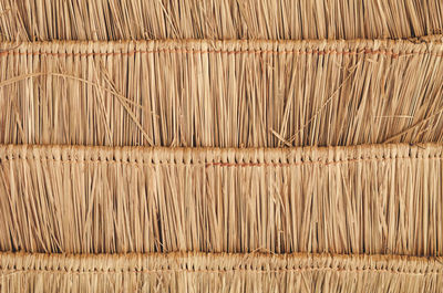 Full frame shot of sticks hanging on wood