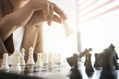 Low section of man playing on chess board