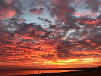Scenic view of dramatic sky over sea during sunset