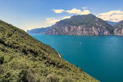 Scenic view of sea and mountains against sky