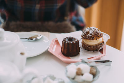 Midsection of woman holding dessert on table
