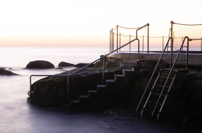 Scenic view of sea against clear sky during sunset