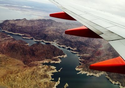 Cropped image of airplane flying over landscape