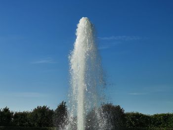 Low angle view of water splashing against sky
