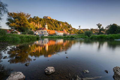 Scenic view of lake by trees against clear sky