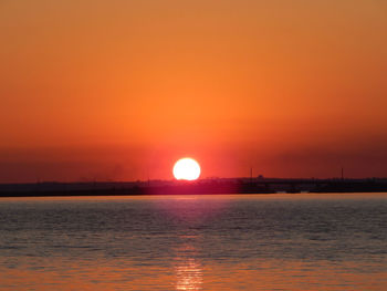 Scenic view of sea against orange sky