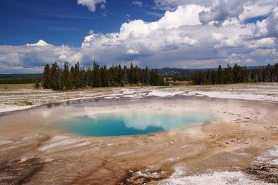 Scenic view of geyser at yellowstone national park against sky